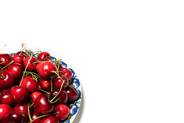 isolated cheeries in the blue plate