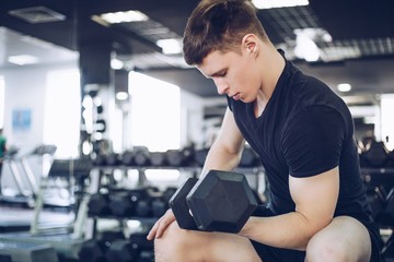 Enhanced bodybuilder training in the gym with weights close-up