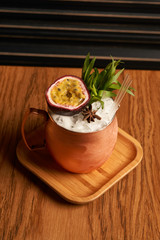 Spicy Mule cocktail on bar table. Alcoholic beverage drink with Rum angostura, reserve rum, dry orange passionfruit ,pure, pineapple pure, spice syrup ingredients, close-up