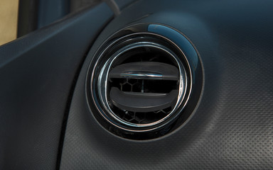 Car interior with closeup of ventilation grille for air conditioning