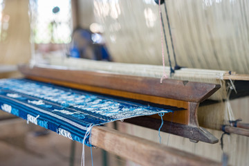 weave silk cotton on the manual wood loom in laos ,thailand,selective focus,vintage color