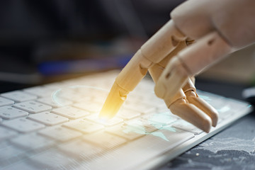 Robot finger point to laptop button with flare light and HUD effect,Robotic , artificial...