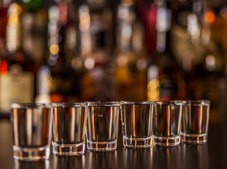 Traditional pure vodka in glasses on a black background, chilled drink