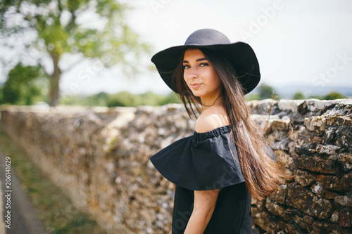 Beautiful Young Sexy Woman Model Of Brunette With Dark Skin In Black Dress And Hat With Beautiful Young Sexy Woman Model Of Brunette With Dark Skin In Black Dress And Hat With