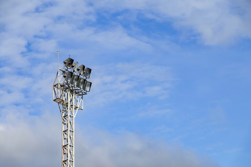 Light stadium or Sports lighting against blue sky. stadium floodlights