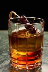 Artichoke Negroni cocktail on bar table. Tart, man's cocktail with Gin alcohol , Rosso, Cynar, close-up