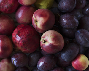 Closeup of plums and other fruits