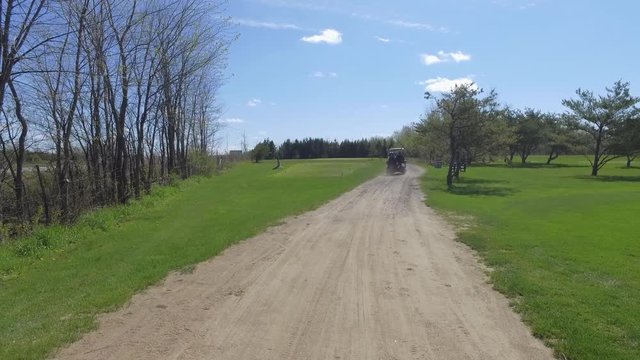golf cart takes off down path 4k