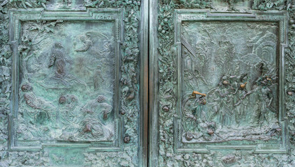 close up of ancient high relief on metal door, Pisa, Italy