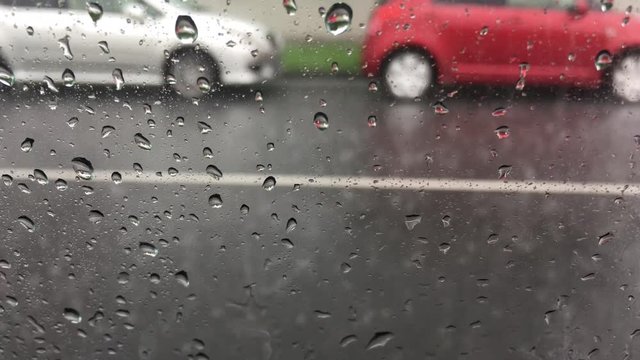 Rain drops over car window on a rainy day