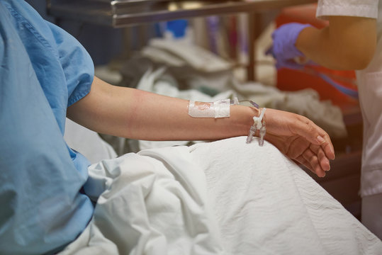 Nurse set catheter in patient hand