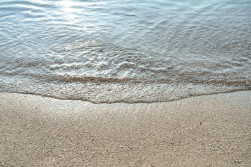 clean ocean waves with the sun light reflection