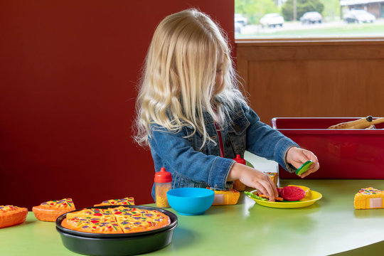 Little girl playing with pretend food