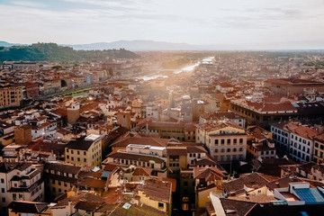 Fototapeta na wymiar FLORENCE, ITALY - JULY 17, 2017: aerial view of beautiful cityscape with historic buildings and rooftops in florence, italy
