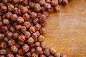 Hazelnut on a wooden background.