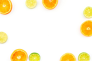 Citrus frame. Oranges and lime round slices composition on white background top view copy space
