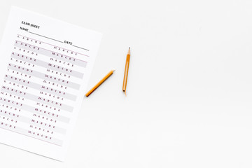 Exam sheet on white table flat lay space for text. Education concept