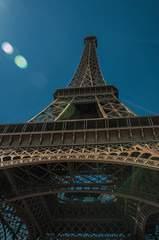Overview of the stunning Eiffel Tower all made of iron with blue sky and sunshine in Paris. Known...