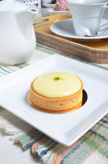 A slice of lemon tart on a plate 