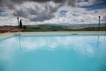 swimming pool against beautiful landscape in Tuscany