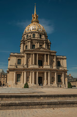 Front facade of Les Invalides Palace with the golden dome in a sunny day and blue sky at Paris. Known as the “City of Light”, is one of the most impressive world’s cultural center. Northern France.