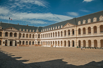 Fototapeta premium View of the inner courtyard of the Les Invalides Palace with old cannons in a sunny day at Paris. Known as the “City of Light”, is one of the most impressive world’s cultural center. Northern France.