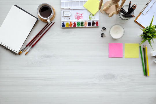 Conceptual image of Artist graphic designer workplace white table. Top view and copy space