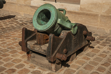 Close-up of old bronze cannon in the inner courtyard of the Les Invalides Palace in Paris. Known as the “City of Light”, is one of the most impressive world’s cultural center. Northern France.