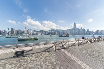 Foto op Canvas Tourist enjoying the scenery of Victoria Harbor of Hong Kong city © leeyiutung