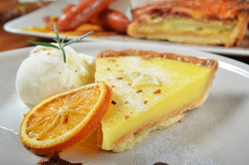 A slice of lemon tart on a plate 