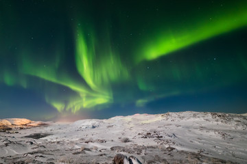 Northern Lights on the shore of the Arctic Ocean.
