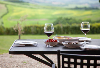 lunch with a view - table against beautiful landscape in Tuscany