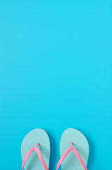Flip-flops on blue background.