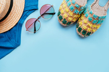 Summer fashion flatlay with gradient round sunglasses, straw hat, espadrille sandals and t-shirt....