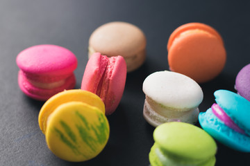 Macaroons on dark background, colorful french cookies macaroons.