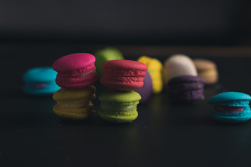 Macaroons on dark background, colorful french cookies macaroons.