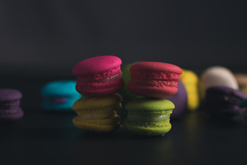 Macaroons on dark background, colorful french cookies macaroons.