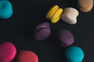 Macaroons on dark background, colorful french cookies macaroons.