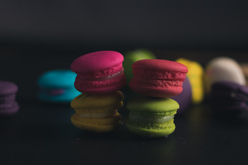 Macaroons on dark background, colorful french cookies macaroons.