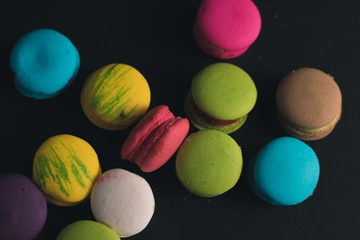 Macaroons on dark background, colorful french cookies macaroons.