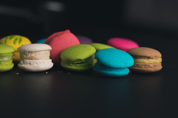 Macaroons on dark background, colorful french cookies macaroons.