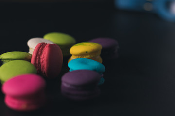 Macaroons on dark background, colorful french cookies macaroons.