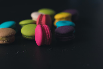 Macaroons on dark background, colorful french cookies macaroons.