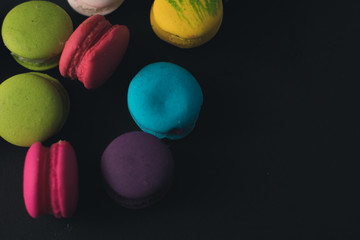 Macaroons on dark background, colorful french cookies macaroons.