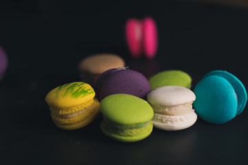 Macaroons on dark background, colorful french cookies macaroons.