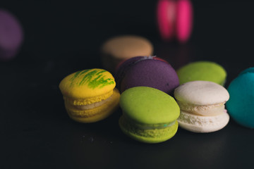 Macaroons on dark background, colorful french cookies macaroons.