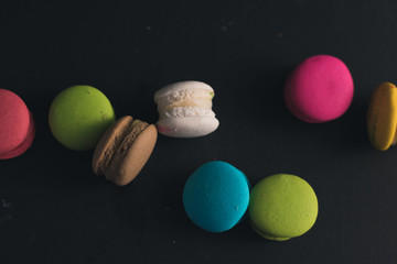 Macaroons on dark background, colorful french cookies macaroons.