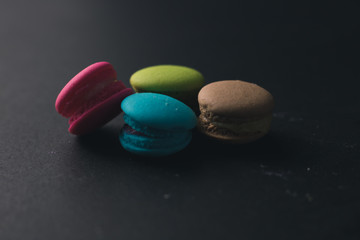 Macaroons on dark background, colorful french cookies macaroons.