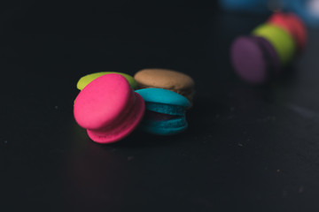 Macaroons on dark background, colorful french cookies macaroons.