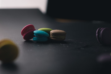 Macaroons on dark background, colorful french cookies macaroons.